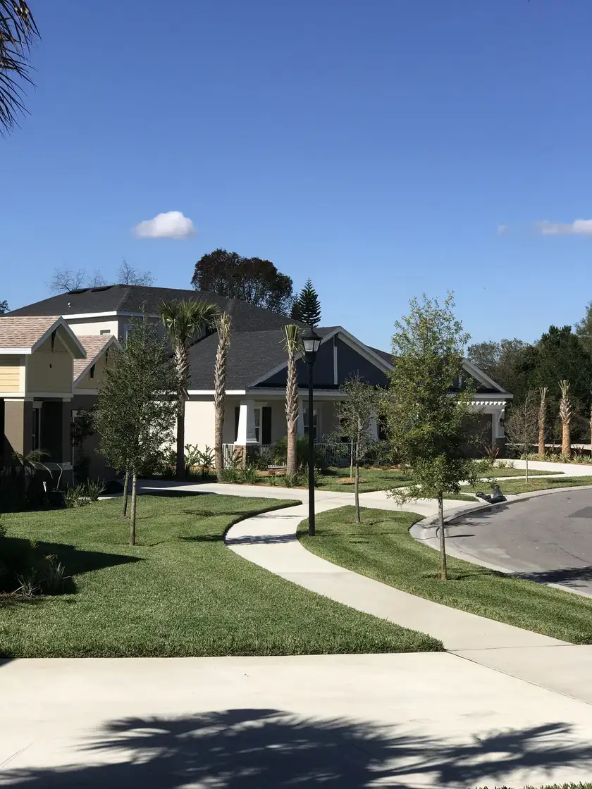 Edged lawn and curved sidewalk in front of a light blue house